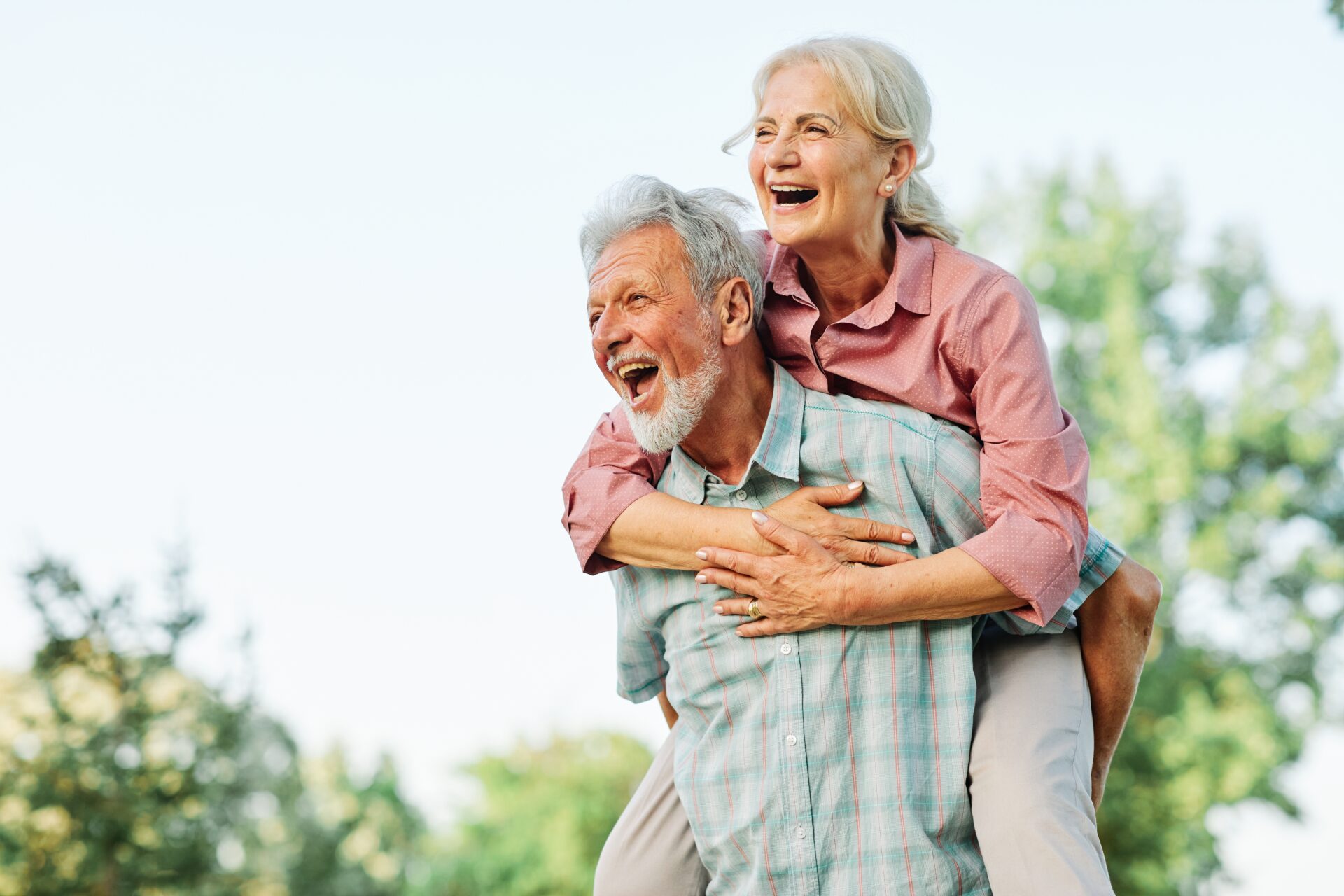 Happy active senior couple having fun outdoors. Portrait of an elderly couple together.